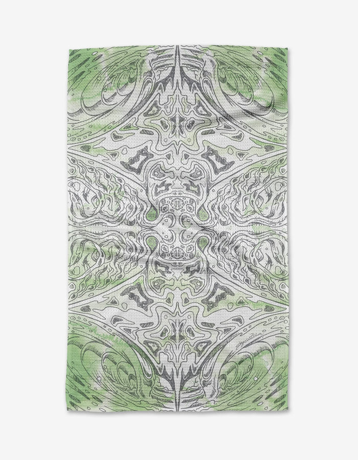 The Manta Tea Towel by Skye Walker is made from Geoweave™ fabric and showcases a detailed, symmetrical green and gray pattern with abstract marbled lines on a white background.