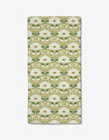 The Danelys Sidron Margarita bar towel is rectangular, made from ultra-absorbent Geoweave fabric, and features white flowers with yellow centers and green leaves on a light beige background in a vintage Art Nouveau style.