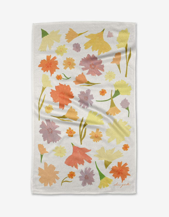 The Marigold Flowers Tea Towel by Elana Gabrielle features a white textured surface with abstract orange, yellow, pink, and green floral patterns, crafted from innovative Geoweave fabric for superior absorbency.