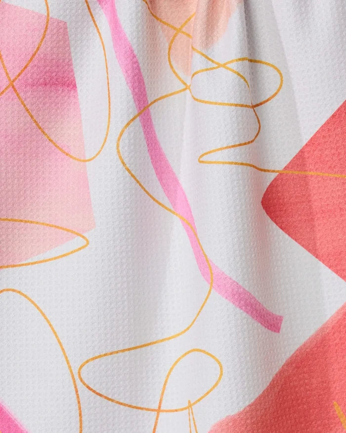 Memories kitchen towel by GEOMETRY features an abstract pattern of pink and peach geometric shapes with yellow curves on a white, textured recycled fabric.