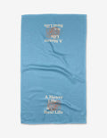 The Messy Life tea towel by Quotes by Christie is blue with a textured Geoweave fabric and “A Messy Life is a Real Life” printed in white and beige, upright at the bottom and upside down at the top.