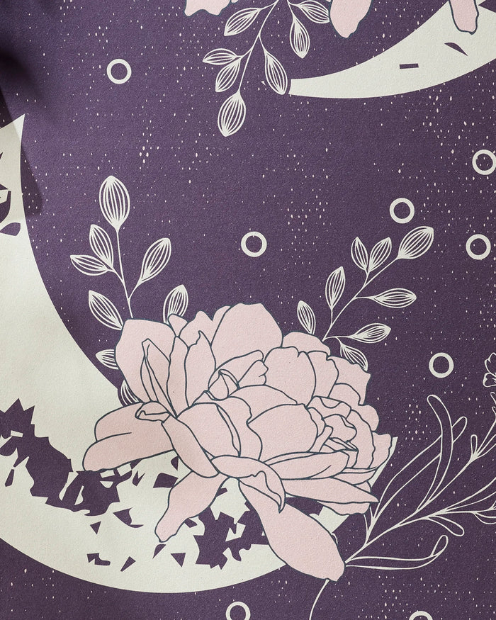 Midnight Garden by Ashley Celena features large pink flowers and white-outlined leaves on a dark purple background with crescent moons and star specks—ideal inspiration for a recycled or non-slip yoga towel design.