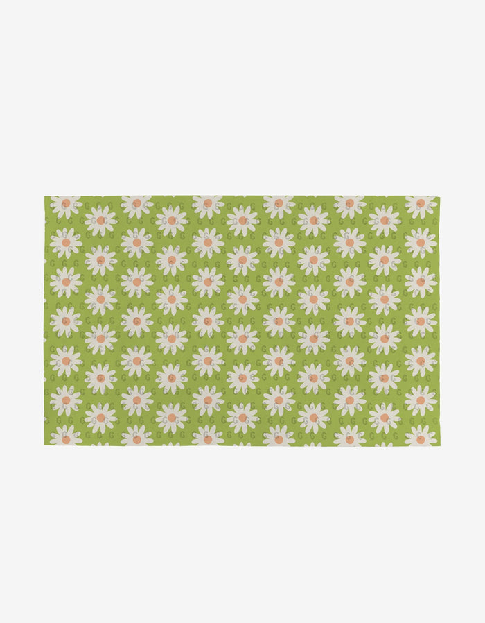 The Mindful Medley mat by Mindfulnice is rectangular and eco-friendly, showcasing a light green background with white and pink daisies arranged in neat rows.