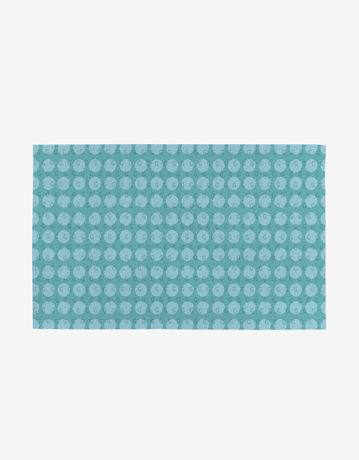 The Mindfulnice Mindful Medley is a rectangular, reusable mat featuring a repeating pattern of light blue pigs on a teal background, shown on a plain white surface.