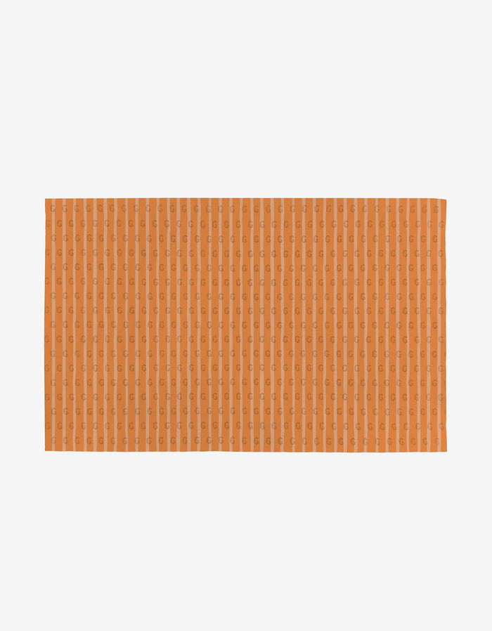 Mindfulnice Mindful Medley is a reusable, rectangular orange towel with a subtle vertical pattern, shown on a white background—an eco-friendly alternative to disposable towels.