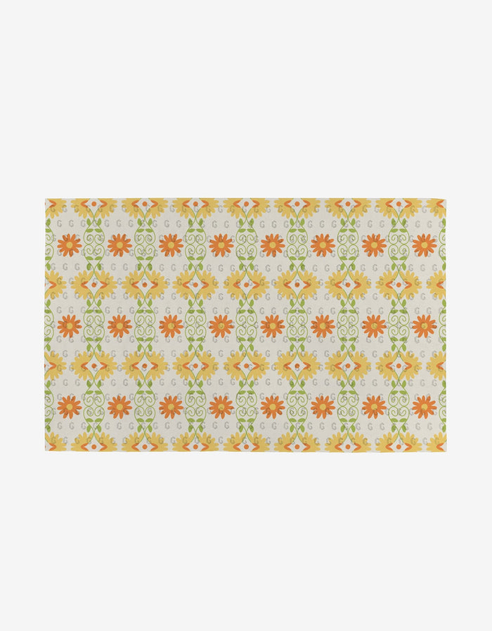 The Mindful Mix rug by Mindfulnice features a rectangular shape with orange, yellow, and green floral and geometric patterns on beige, made from eco-friendly recycled materials (not paper towels).