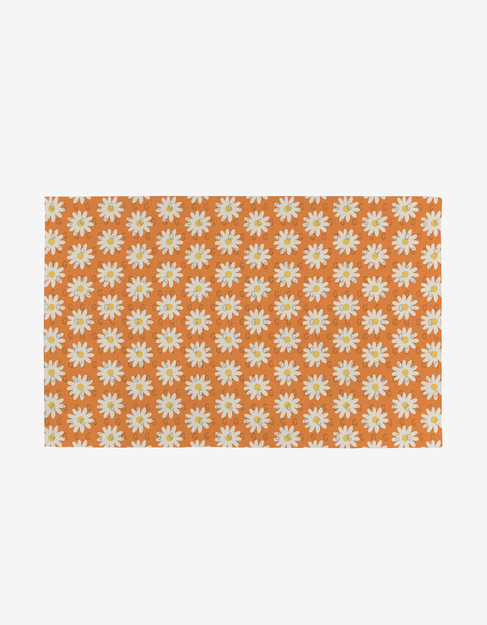 Mindful Mix by Mindfulnice: Rectangular orange cloth with a white and yellow daisy pattern, made from eco-friendly post-consumer recycled materials.