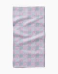 The Hufton Studio Mini Flowers and Stripes Check Pink and Green Bar Towel has a rectangular shape with alternating pink floral, green check, and striped squares, crafted from slightly wrinkled Geoweave fabric.