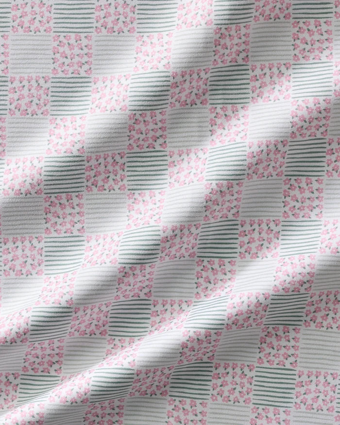 Mini Flowers and Stripes Check by Hufton Studio features a checkered fabric with pink floral prints and green stripes—ideal for charming reusable cloth napkins or a stylish dinner napkin set.
