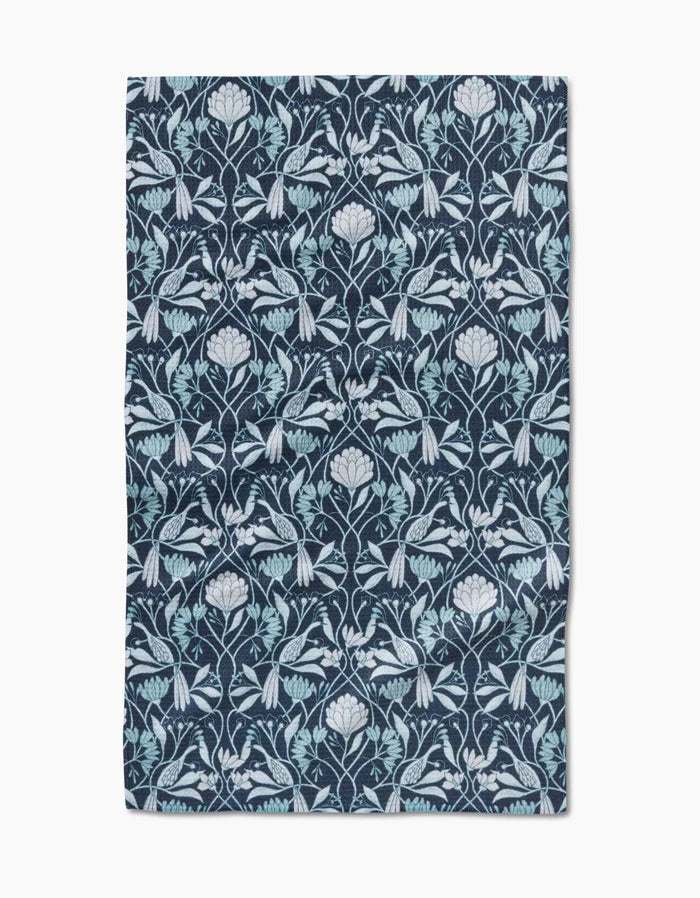 The Mirielle by Amy MacCready is a rectangular cloth made from ultra-absorbent Geoweave fabric, featuring an intricate, symmetrical floral and leaf pattern in light blue and white on a dark blue background.