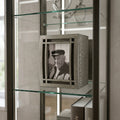 Wooden curved portrait urn with a black and white photo of an elderly man on a glass shelf.