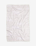 The GEOMETRY Mom blanket features white Geoweave fabric with repeated words MOM, MOTHER, and MOMMY in varied sizes and fonts in a light, semi-transparent print. The blanket is shown flat with some visible wrinkles.