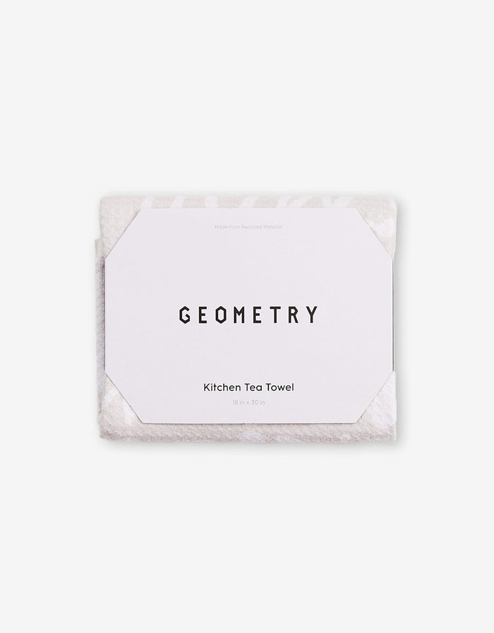 A folded white GEOMETRY Mom kitchen tea towel, made of ultra-absorbent Geoweave fabric with a geometric paper label reading GEOMETRY and Mom Kitchen Tea Towel 18 in x 30 in, displayed on a plain white background.