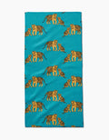 The Mommy and Me Bar Towel by Sarah Holden showcases orange and black illustrated tigers and cubs in playful poses on soft Geoweave fabric with a turquoise background.