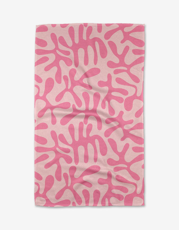 The Monochrome Morning tea towel by Marina Solodka features a light pink Geoweave fabric with an abstract pattern of darker pink, coral-like shapes, shown flat with gentle wrinkles.
