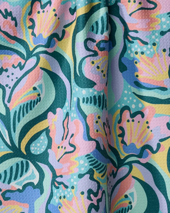 Moody Flowers by Masha Volnova features an abstract floral pattern in pastel pink, teal, yellow, and purple on a textured quick-drying towel—bringing style and function to your home.