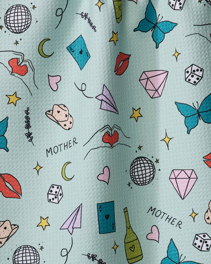The Mother tea towel by Sarah Holden features hand-drawn diamonds, butterflies, lips, stars, moons, and more. Made from quick-drying recycled materials.
