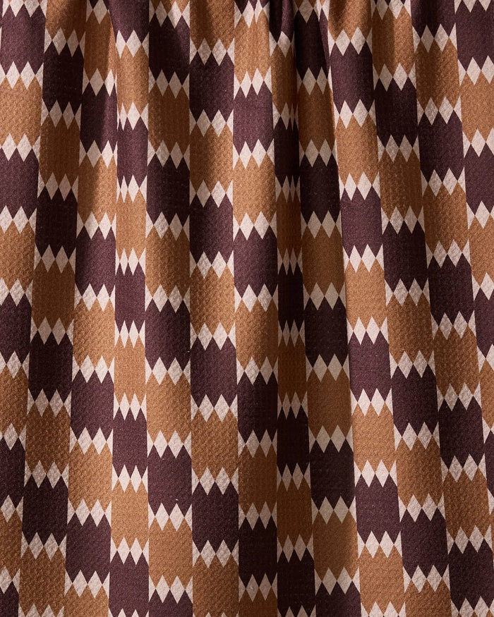 The Geometry Mountain Song recycled kitchen towel features a visually dynamic geometric pattern with alternating brown, tan, and beige diamond shapes in vertical rows.