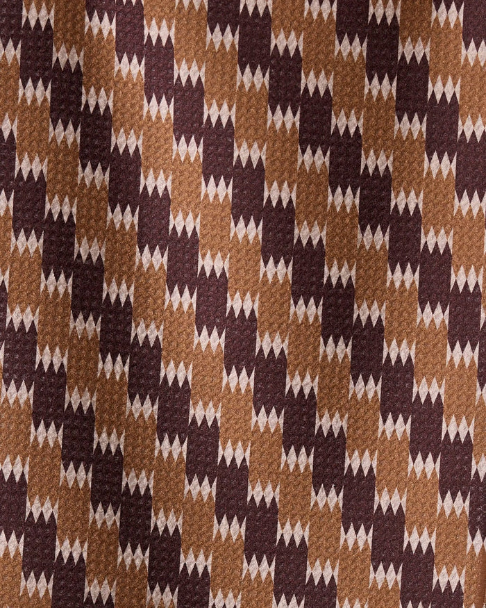 Mountain Song by Geometry is a brown fabric made from recycled materials, featuring dark brown and tan rectangles with small white diamond shapes for a textured, dynamic look.