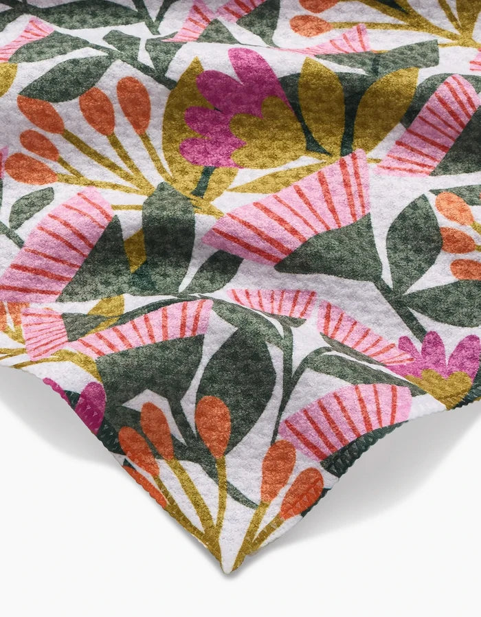 Lisa Nelson’s Moxie Mauve features soft Geoweave fabric with a vibrant floral pattern in pink, orange, and purple flowers plus green leaves on white. The fabric is neatly folded at one corner.