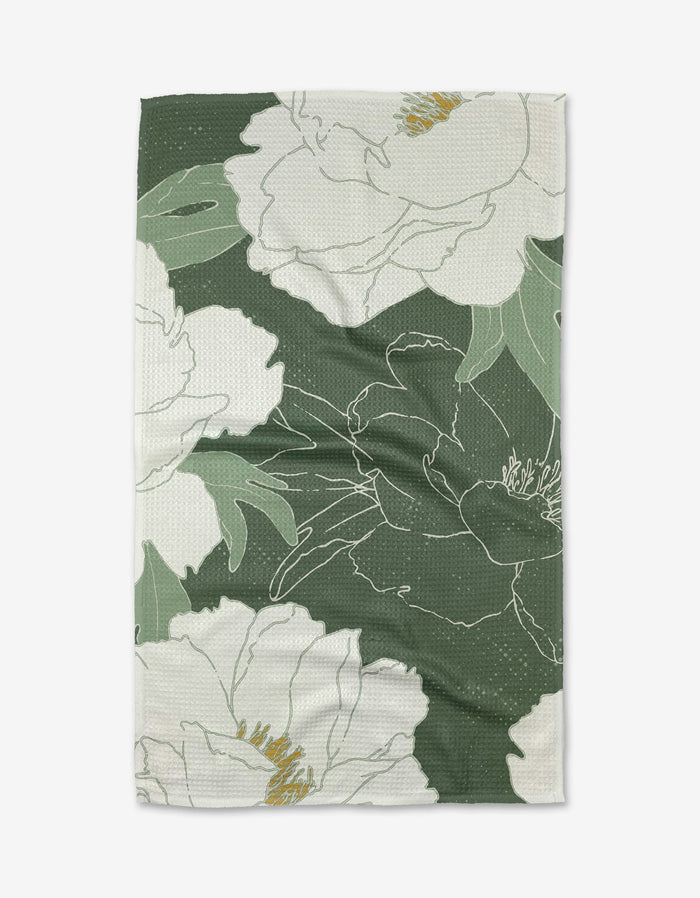 A green and white My Dear Itoh Tea Towel by Ashley Celena, featuring a large floral pattern with outlined white flowers, yellow accents, and ultra-absorbent textured Geoweave fabric.