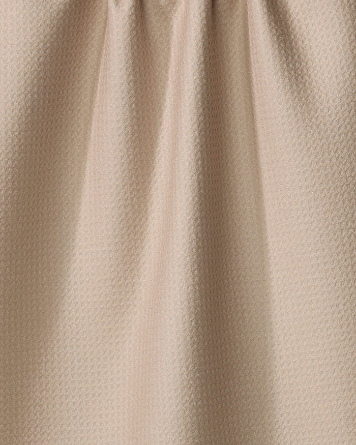 Close-up of “My Happy Place” by Kelsi Fullmer: an eco-friendly, light beige textured fabric with small geometric patterns and soft vertical folds—perfect for a stylish kitchen towel.