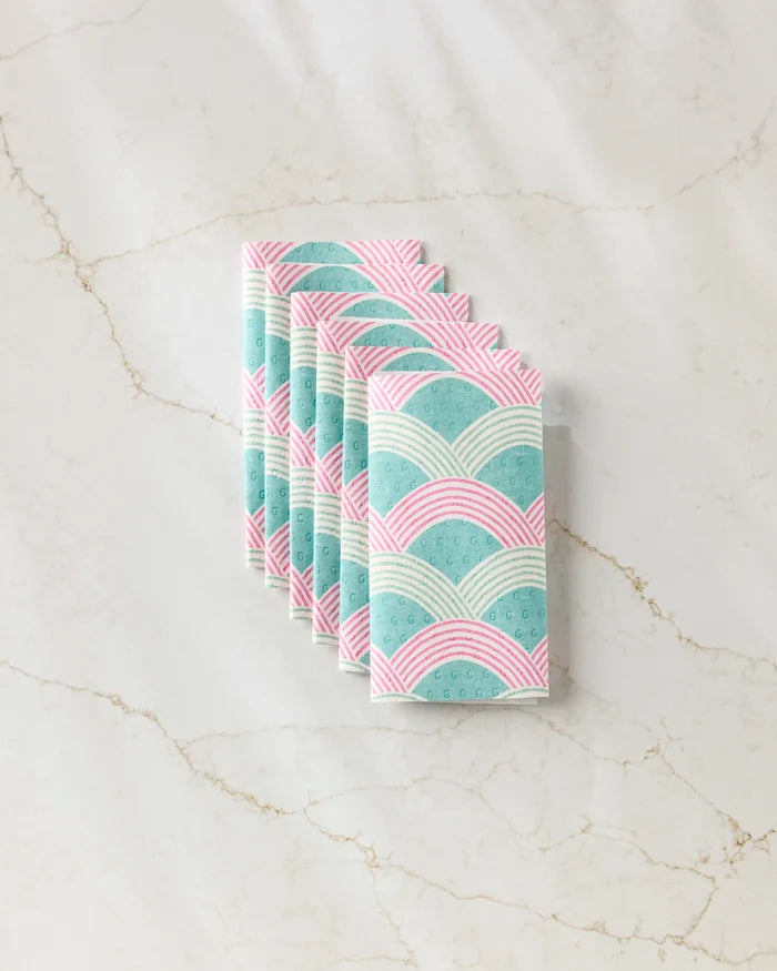 Six Nalin reusable paper towels by Amy MacCready, featuring a pastel arch pattern in pink, teal, and white, are neatly folded and set on a light marble surface.
