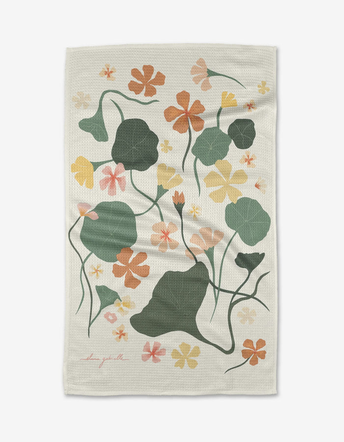 The Nasturtiums Tea Towel by Elana Gabrielle features a white, textured Geoweave fabric with an illustrated floral pattern of green leaves and colorful flowers, and winding stems across the surface.