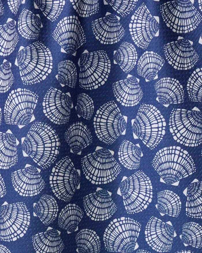 A close-up of Kris Ruff's Nautical Seashells fabric shows blue material with white seashells in various orientations and intricate line details, resembling a quick-drying towel.