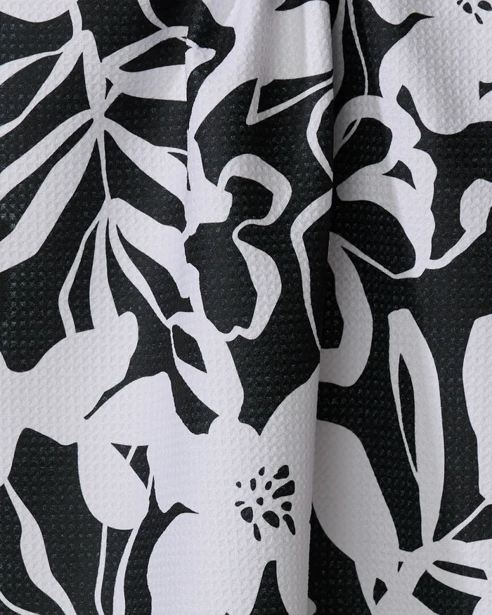 Close-up of the Night Meadow tea towel by Marina Solodka, featuring ultra-absorbent recycled material and a textured black and white abstract floral and leaf pattern.