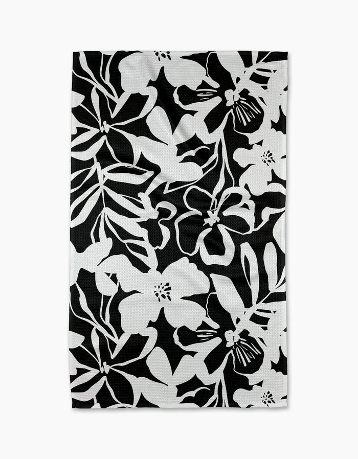The Night Meadow dish towel by Marina Solodka features a bold black and white floral pattern—ideal as an eco-friendly kitchen or tea towel.