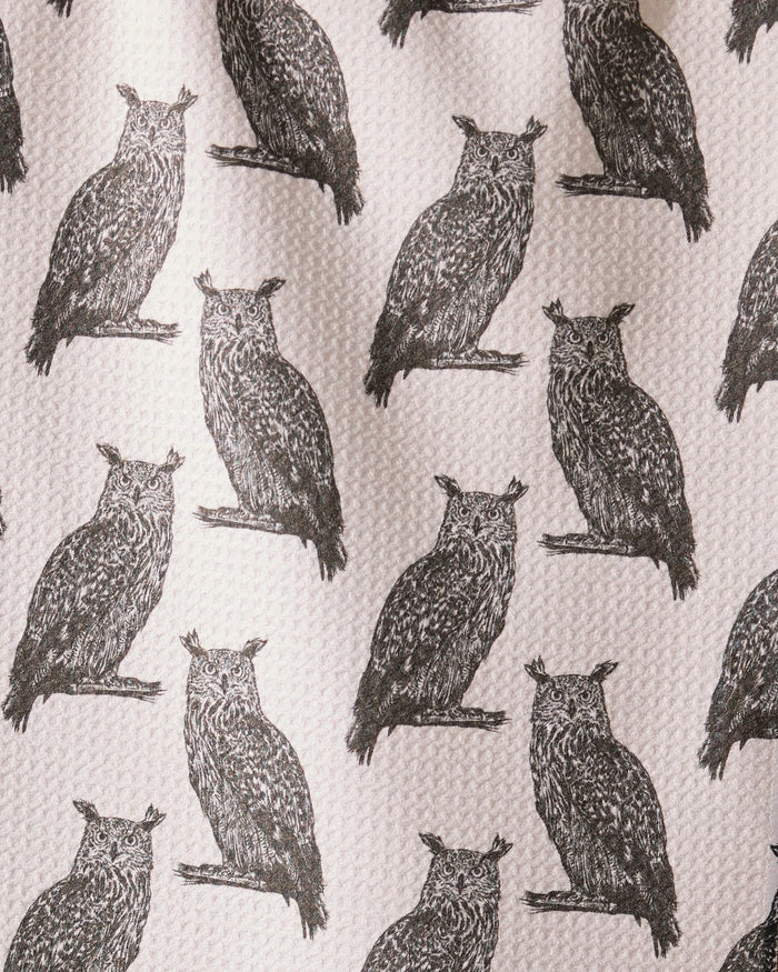 Nocturne by Geometry features detailed black owl illustrations facing forward, evenly spaced on an ultra-absorbent towel made from recycled materials with a textured, off-white background.