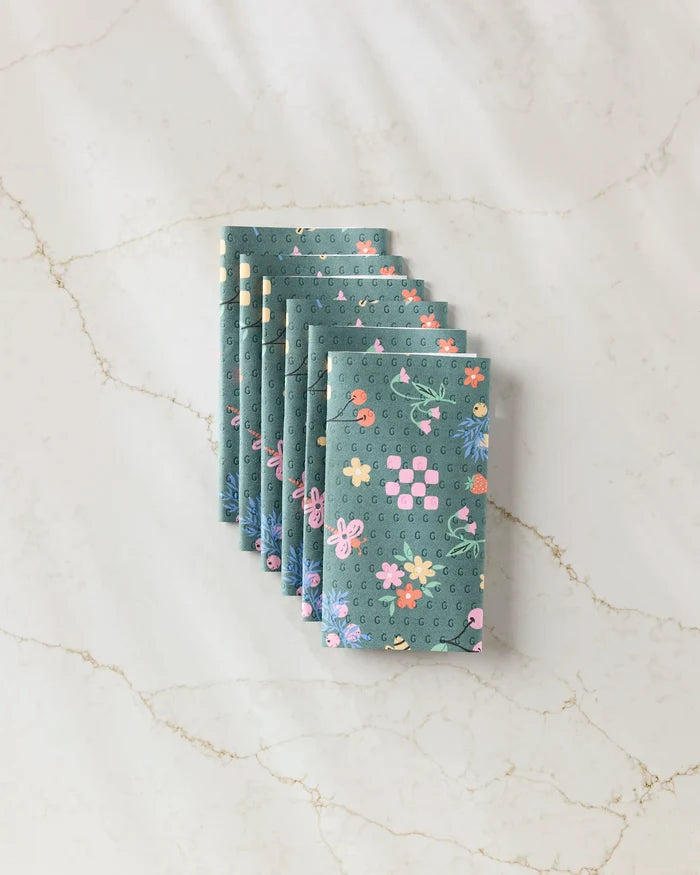 The North Meadow Bright Night envelopes by Charlie Rowan Designs, featuring vibrant floral patterns, provide a stylish and eco-friendly alternative to disposable paper towels for gift wrapping.