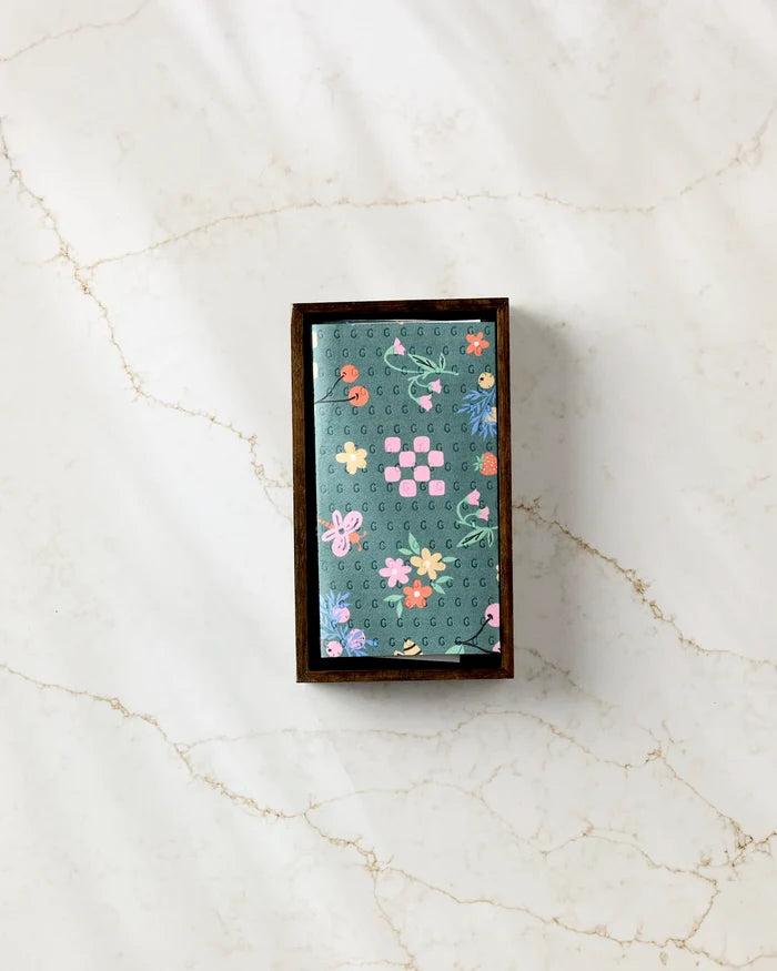 North Meadow Bright Night by Charlie Rowan Designs—a rectangular green chocolate bar featuring a colorful floral pattern and pink squares, elegantly boxed in brown on white marble—an eco-friendly gift alternative to disposable paper towels.