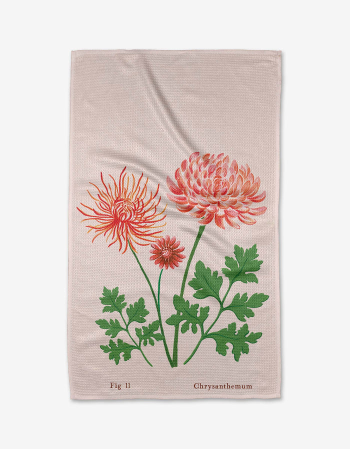 The Linda Fox November Chrysanthemum Tea Towel in beige showcases three red and pink chrysanthemums with green leaves, “Fig 11” and “Chrysanthemum” text, and is crafted from post-consumer recycled materials.