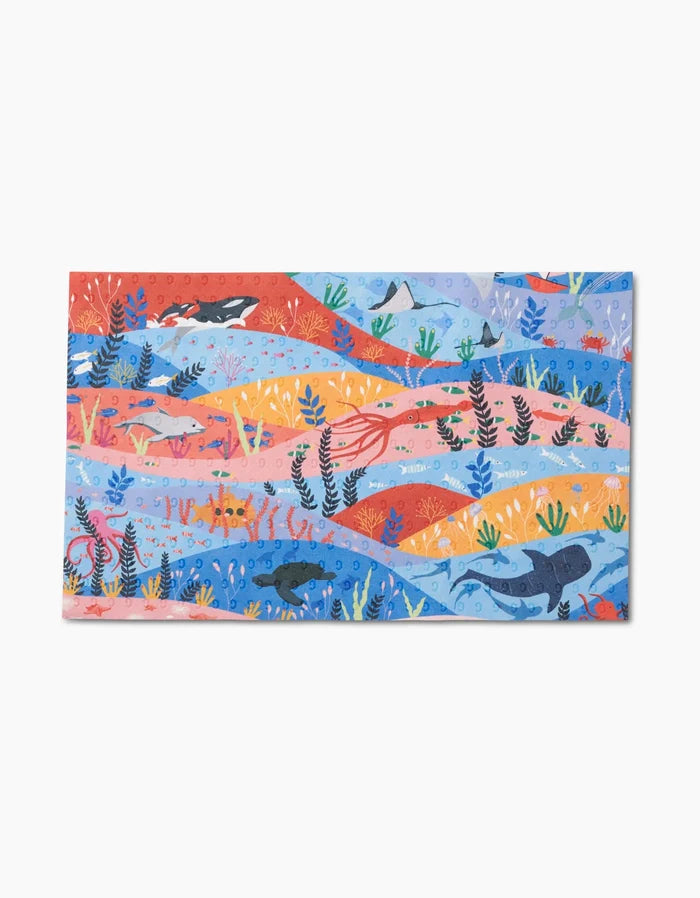 Oceans by Ceyda Alasar features a vibrant underwater illustration with sharks, fish, sea plants, coral, and an octopus on eco-friendly reusable paper towels made from post-consumer recycled materials.