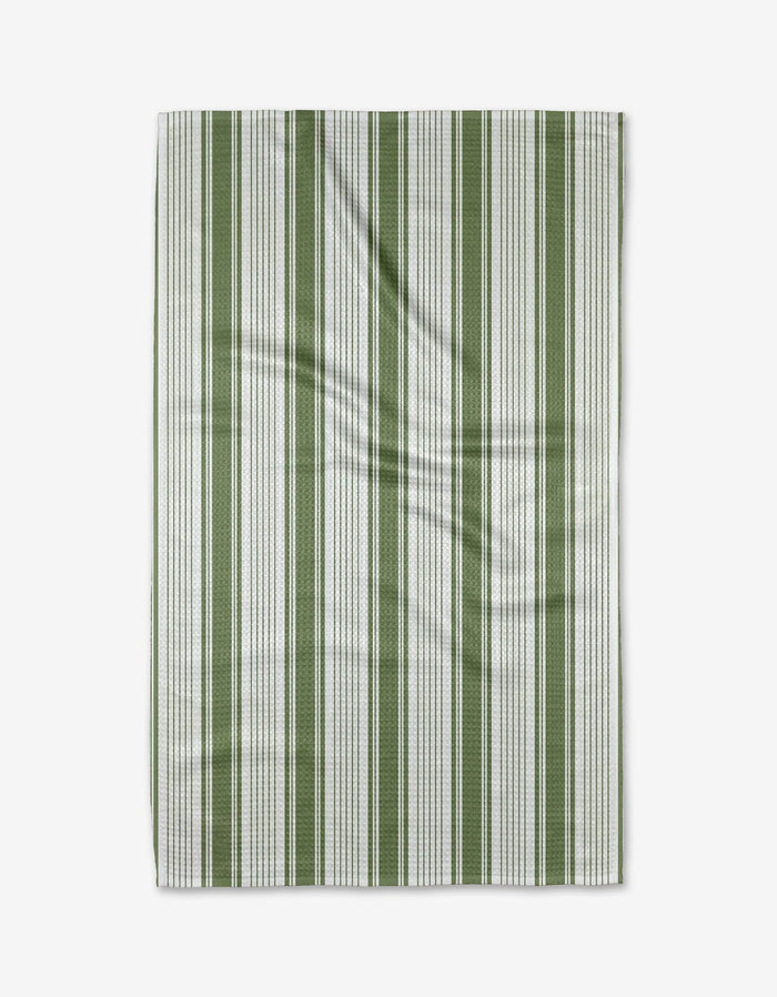 The Aubrey Fairchild Of the Same Stripe tea towel features vertical green and white stripes on Geoweave™ fabric, adding subtle texture and slight wrinkles, displayed against a white background.