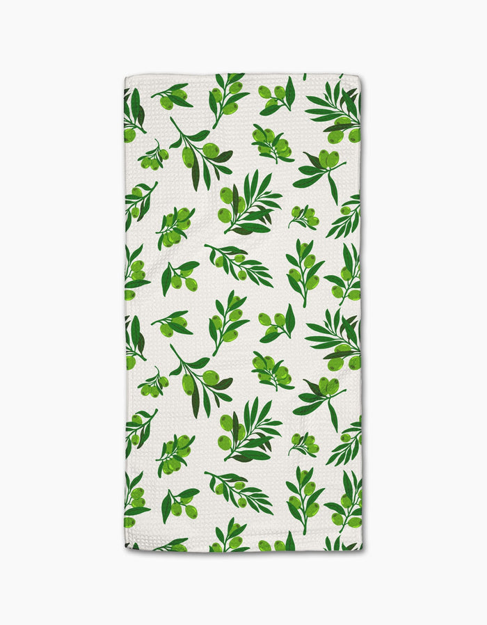 The Olive Grove towel by Geometry features ultra-absorbent white fabric with a stylish repeating green olive branch pattern—perfect as a chic bar towel for your kitchen.