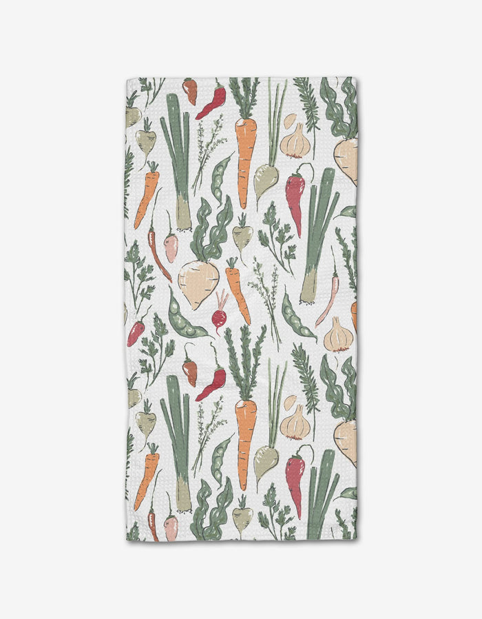 The Organic Vegetable kitchen bar towel by Hufton Studio features hand-drawn veggies—carrots, leeks, turnips, garlic, radishes, and peas—on a white background and is made with absorbent Geoweave fabric.