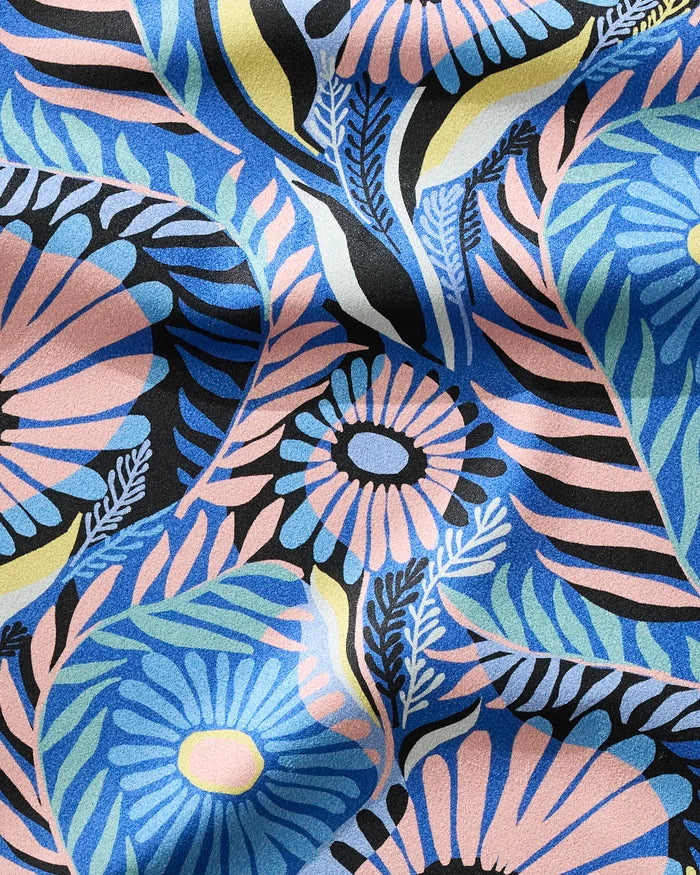 Palm Beach by Masha Volnova features colorful fabric with vibrant blue and pink floral patterns, black accents, and green leafy shapes. This ultra-absorbent material is ideal for a fitness towel—soft, quick-drying, and stylish.
