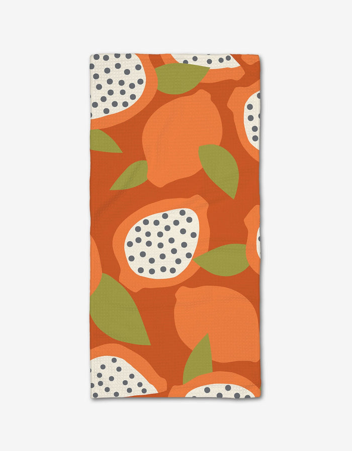 The Lizzie Clark Papaya Playtime bar towel features a bold pattern with whole oranges, citrus slices, and green leaves on an orange background, made from Geoweave fabric for superior absorbency.