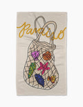 The Geometry Paraiso towel features ultra-absorbent Geoweave™ fabric, “Paraiso” in yellow cursive at the top, and a mesh bag illustration holding colorful seashells, a starfish, and seaweed.