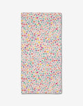 The Pastel Petal bar towel by Rebecca Bobko features pink, yellow, red, green, and purple polka dots on a white background. Made from eco-friendly Geoweave fabric.
