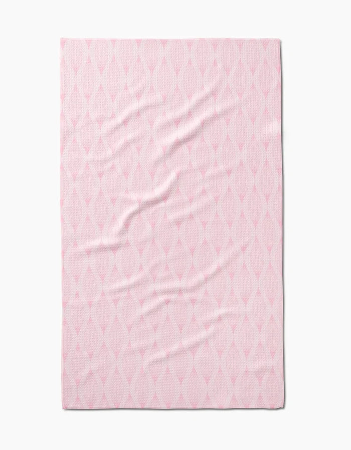 The Shelley Smith Patterned in Pink blanket features Geoweave fabric and a subtle diamond-shaped lattice in light and deeper pink, shown laid flat with gentle wrinkles.