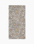 The Paulette bar towel by Amy MacCready showcases a bold black and tan floral pattern with large, stylized flower shapes on ultra-absorbent beige Geoweave fabric covering the entire rectangular surface.