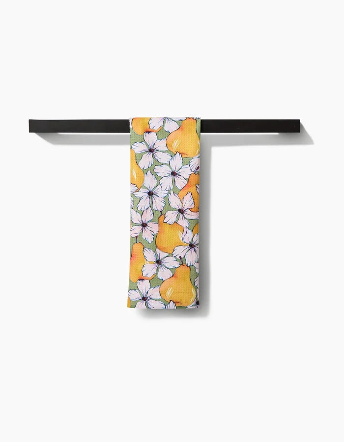 The Pears Petals tea towel by Maayan Alper-Swan features a vibrant yellow pear and white flower design on soft Geoweave fabric, neatly displayed over a black bar with a clean white background for style and durability.