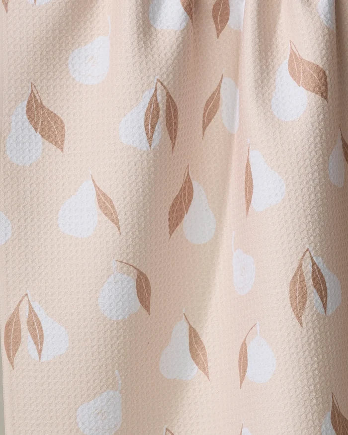 A close-up of the Pears Kitchen Tea Towel by Hufton Studio, featuring light pink Geoweave fabric with white pear shapes and brown leaves for a soft, subtle fruit-themed design.