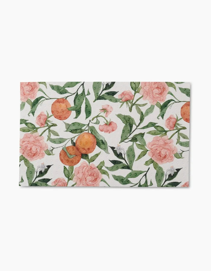 Peony For Your Thoughts by Aubrey Fairchild features pink peonies, green leaves, and orange citrus clusters on white—ideal for eco-friendly reusable paper towels.