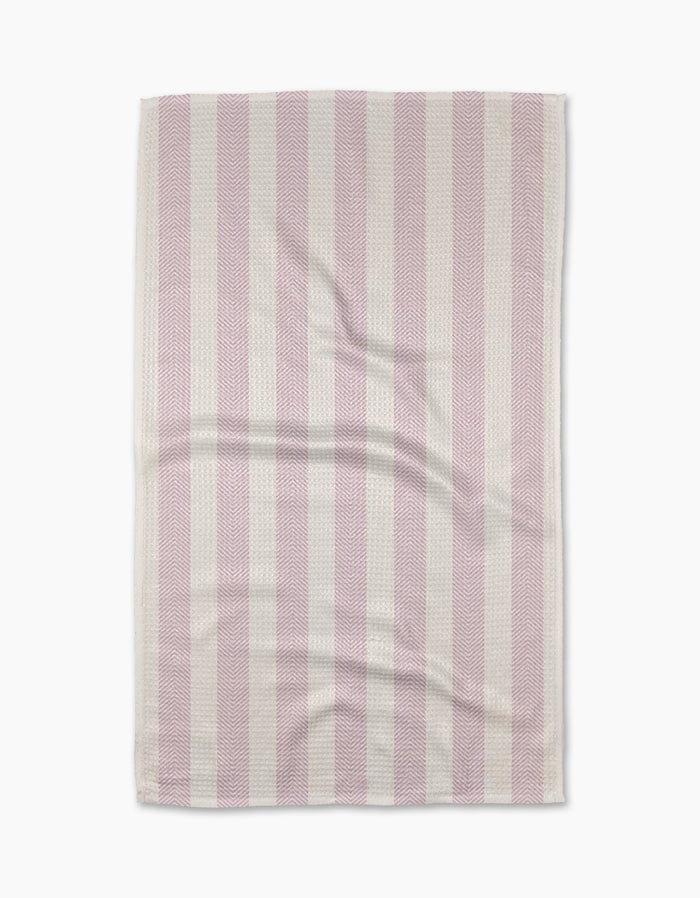 The Teri the Butter Pink Chevron Stripe tea towel features alternating vertical pink and white stripes, a slightly wrinkled texture, and neatly finished edges, displayed against a white background.