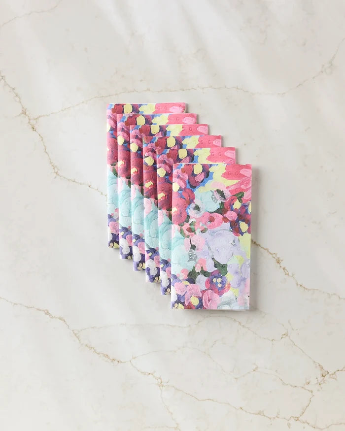 The "Pink Fields of Joy" notebook set by Ania Zwara Art features six vibrant, abstract-covered notebooks made from eco-friendly paper towels, beautifully fanned out on a light marble background.